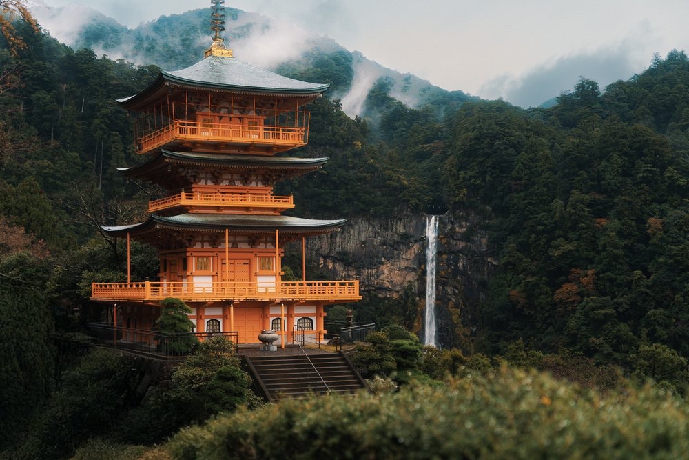 A pagoda and waterfall in the mountains, Japan